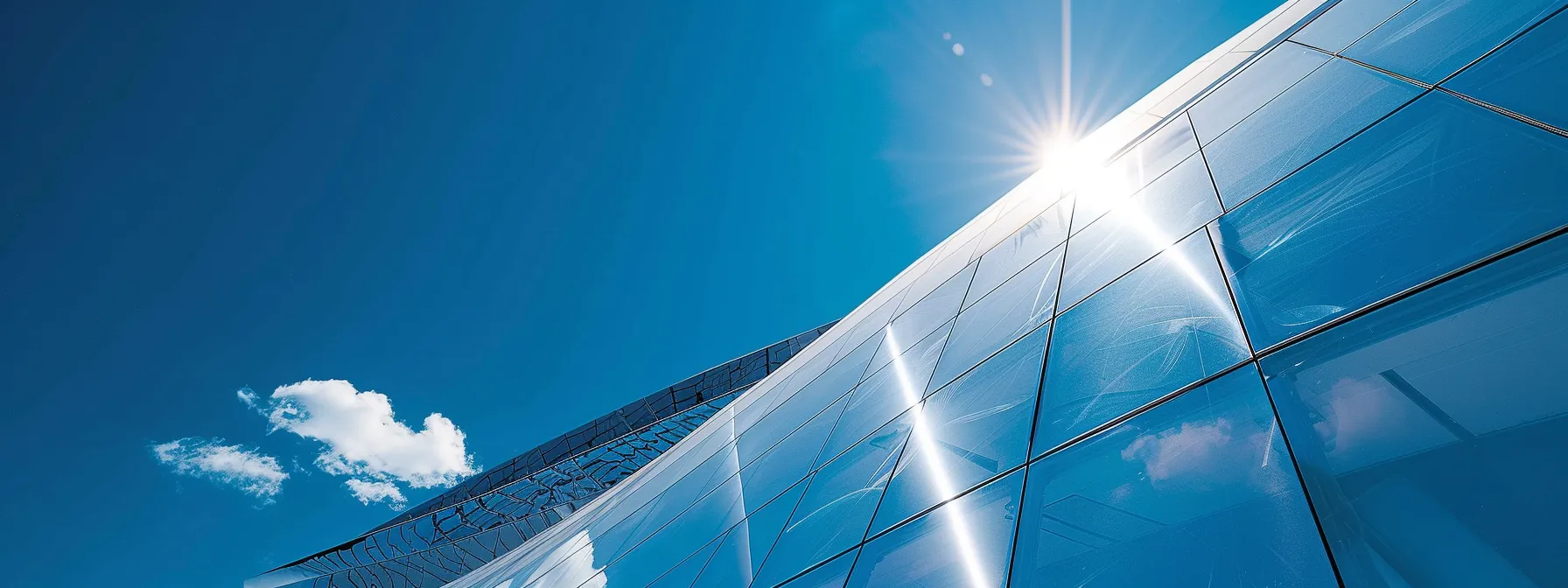 a sleek, modern rooftop covered in reflective solar panels under a bright blue sky.